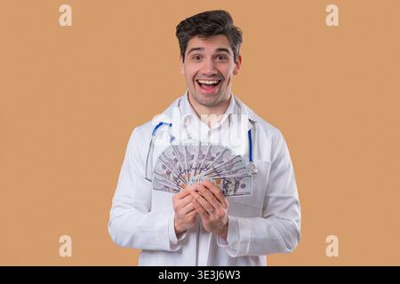 Rich Doctor Man With Usd Money. Handsome Medical Health Care Worker In White Stock Photo