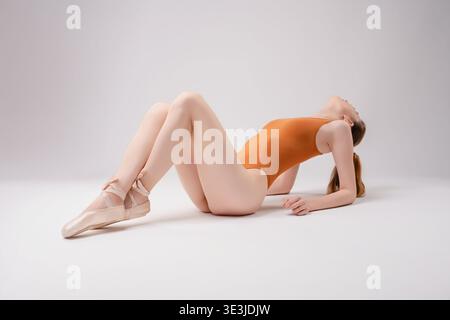 Stunning woman poses elegantly in a beauty studio with soft lighting Stock Photo