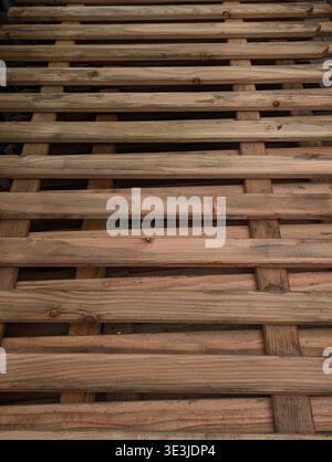 Closeup Stacked Wooden Slats Pallet With Linear Gaps, Aged Grain, Nail Joins And Warm Workshop Light Suggesting Carpentry Workshop Or Reclaimed Materi Stock Photo