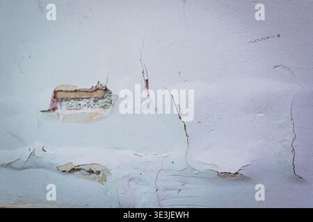 crack white concrete wall background, old worn out bricks wall with hole, painter and renovation work Stock Photo
