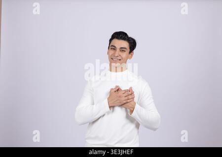 Man holding hands on chest in gratitude Stock Photo