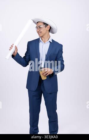 Businessman in formal suit holding a white blueprint in studio Stock Photo