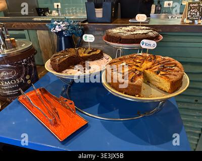 Italian cakes served at a breakfast buffet in Rome, Italy. Labels indicate vegan and gluten-free options available. Stock Photo
