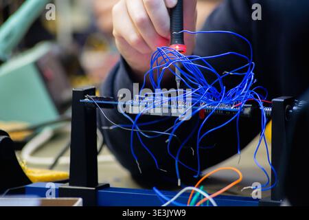 close up of a caucasian hand holding a soldering iron Stock Photo