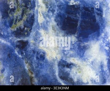 Blue and white background on the surface of the natural mineral gemstone sodalite Stock Photo