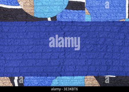 Textile background made from stitched, wrinkled blue silk and patchwork Stock Photo