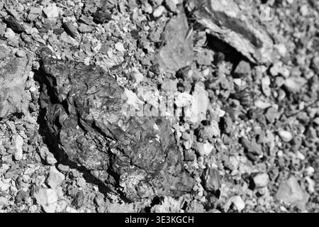 Close-Up Black-And-White Photograph Of Rocky Shoreline Pebbles And Shell Fragments On Fishermans Trail, Portugal. Stock Photo