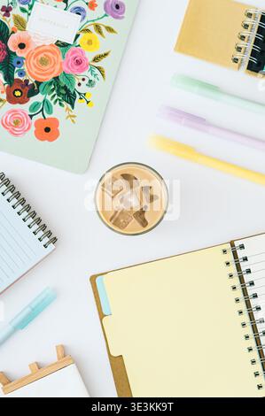 Workspace with iced coffee, notebooks and colorful pens. Study or work concept. Flat lay background. Top view. Stock Photo