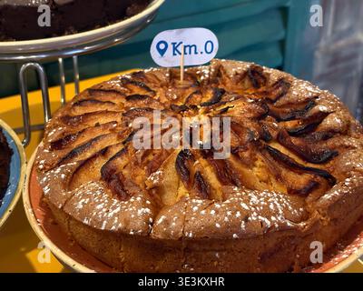Apple cake served at a hotel buffet breakfast in Rome, Italy, featuring a 'Km. 0' marker indicating local sourcing. Stock Photo