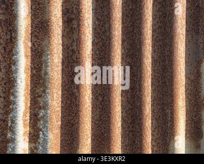 Close texture of rusted metal wall with vertical grooves. Stock Photo