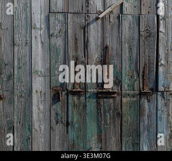 Detailed view of aged timber with peeling paint, highlighting natural decay and rustic charm. Stock Photo