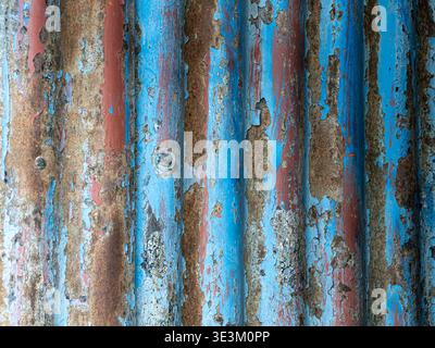 Rusted surface with bright blue tones and textured decay. Stock Photo