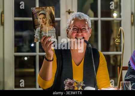 Mona Gabriel holds up a penny dreadful by Hedwig Courths-Mahler. Under the pseudonym Clara Bachmann, Mona Gabriel and a co-author published the biographical novel *A Happy Ending: The Rocky Road of Hedwig Courths-Mahler* in October 2025. Leipzig, Saxony, Germany Stock Photo