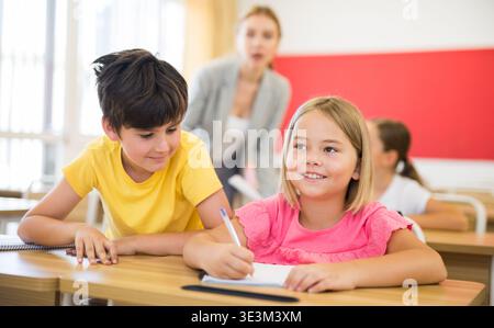 Kid cheating during test Stock Photo