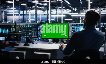 Data center engineer using machine learning algorithms on green screen PC to analyze datasets. Server farm worker using AI neural networks on mockup computer to recognize data patterns, camera A Stock Photo