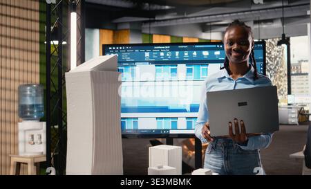 African american developer using modern design software to create a vision for a urban infrastructure, focusing on property construction and residential area planning. Innovation hub. Stock Photo