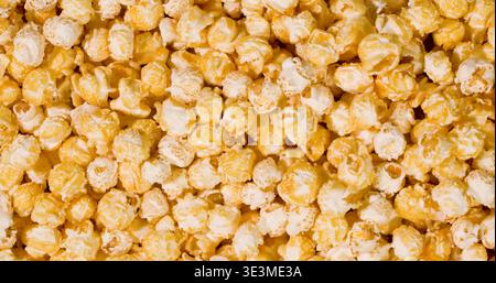 Popcorn in various flavors spread across a flat surface at a cinema snack bar during a movie screening event Stock Photo