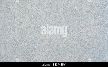 Textured light gray wall surface with subtle variations in tone and pattern, suitable for backgrounds in design projects or interior applications Stock Photo