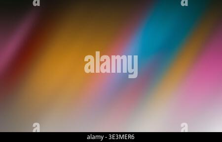 Abstract blurred background with vibrant colors including blue, yellow, pink, and orange creating a smooth gradient effect suitable for artistic or Stock Photo