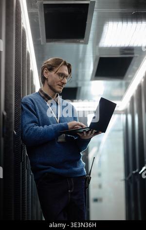 Caucasian Adult Man Using Laptop While Working in Data Center Stock Photo