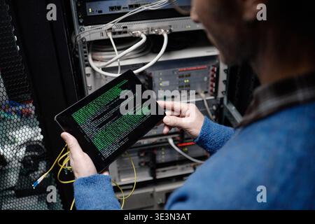 Middle Aged Caucasian Man Using Tablet While Working in Server Room Stock Photo