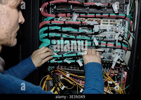 Caucasian Adult Man Configuring Network Server Equipment in Data Center Stock Photo