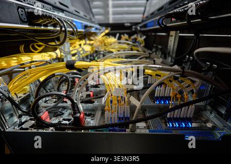 Network Servers Processing Data with Fiber Optic Cables in Data Center Stock Photo