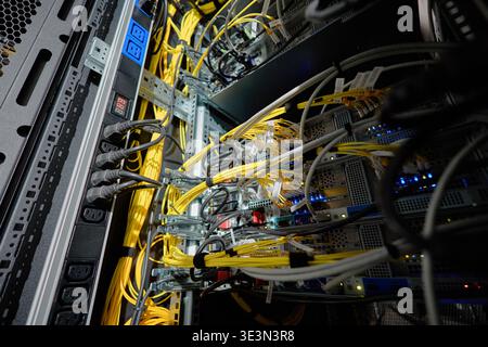 Network Servers Processing Data with Multiple Ethernet Cables in Data Center Stock Photo