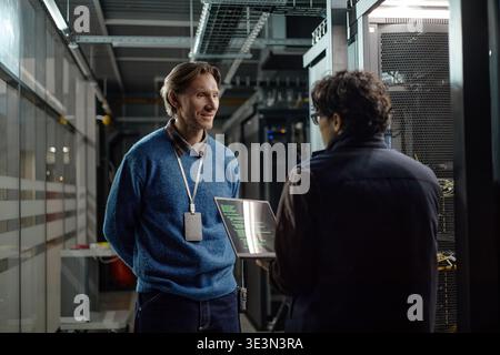 Middle Aged Caucasian Man Discussing Data Security with Young Adult Man Stock Photo