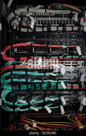 Network Server Rack Displaying Data Cables and Hardware Equipment Operating Stock Photo