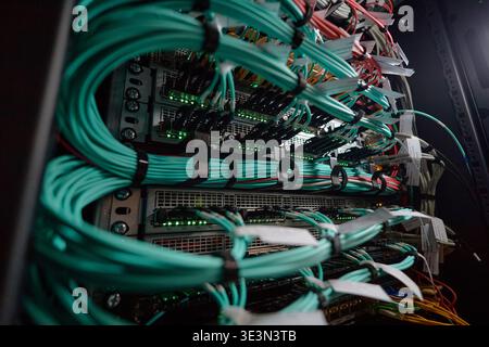 Network Server Rack Displaying Cables and Hardware Components Operating Stock Photo