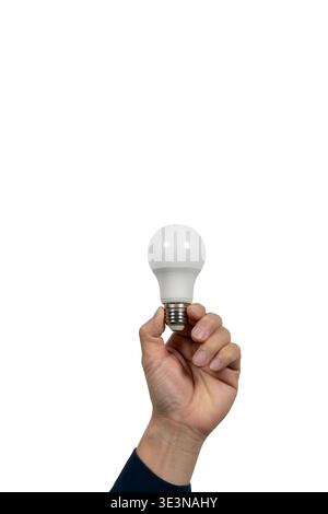 Close-up of a hand holding an LED light bulb isolated on light gray background with copy space, symbolizing energy saving, lighting, electricity, inno Stock Photo