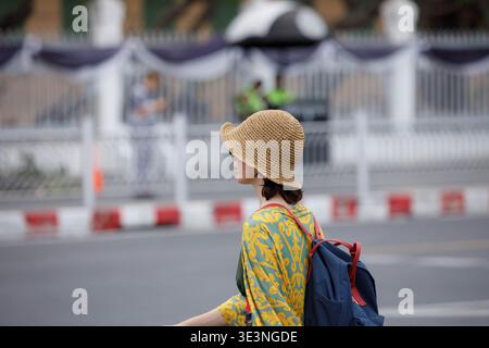 Female backpacker walking and exploring new city in Bangkok, travel journey unfolding step by step, side profile. Stock Photo