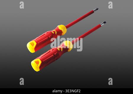 Dielectric screwdrivers with insulated rod. Close-up. Isolated on grey background. Stock Photo
