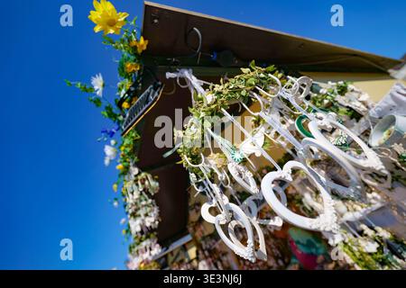 Vienna, Austria - April 4, 2025: white heart decorations hanging against blue sky Stock Photo