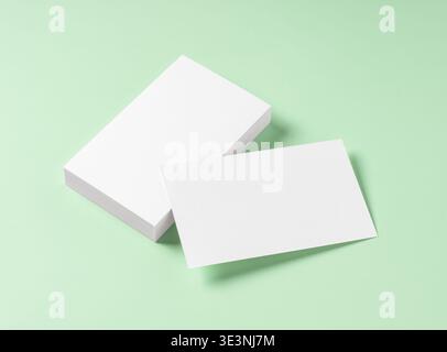 Blank white business cards mockup on light green background Stock Photo