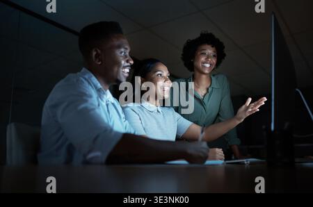 Creative, team and group with computer at night, proofreading and planning for magazine publication. Newsroom, journalist and black people with Stock Photo