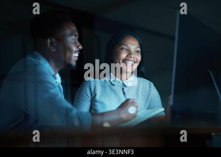 Creative, team and happy with computer at night, proofreading and planning for magazine publication. Newsroom, journalist and black people with Stock Photo