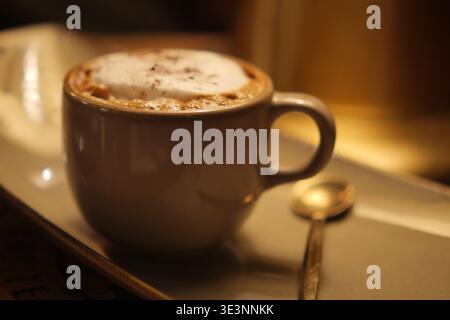 Hot coffee in white cup on a saucer with spoon Stock Photo