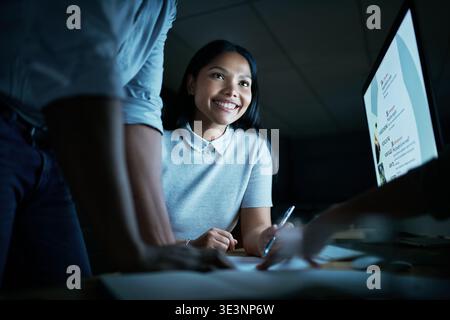 Businesswoman, team or computer screen with meeting at night for ui testing, planning or app launch. UX display, web developers and discussion in Stock Photo