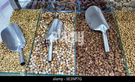 Nuts and snacks displayed in glass trays for sale Stock Photo