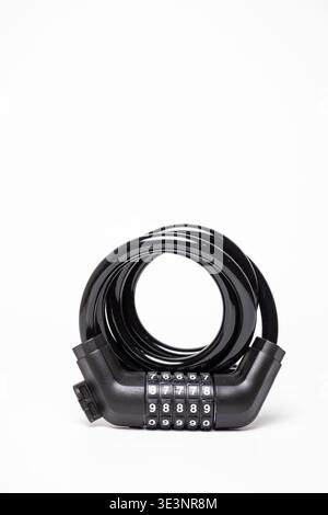 Close-up of a sturdy black combination bike lock with coiled flexible cable and numbered code wheels, neatly arranged on a clean white background. Stock Photo