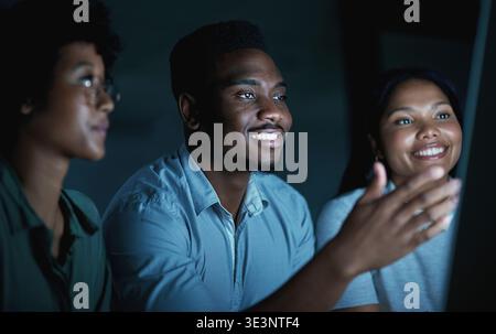 Creative, team and deadline with computer at night, journalist and planning for magazine publication. Newsroom, black people and happy with technology Stock Photo