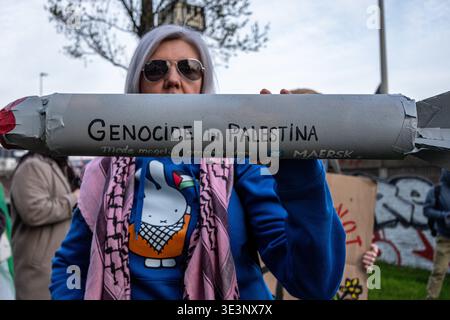 Rotterdam, South-Holland, The Netherlands. 23rd Mar, 2026. 23/03/2026 - A pro-Palestine demonstration organized by various activist groups against Maersk and the transit of goods for the Israeli army through the Port of Rotterdam. A woman is holding a fake paper missile with the words "Genocide in Palestine, made possible by Maersk"" written on it. (Credit Image: © Storm Groenendijk/ZUMA Press Wire) EDITORIAL USAGE ONLY! Not for Commercial USAGE! Stock Photo