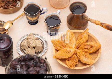 Ramadan Sweet Treats and Coffee Assortment on the table. Baklava, halva for dessert. Food and drink. Dates fruit. Stock Photo