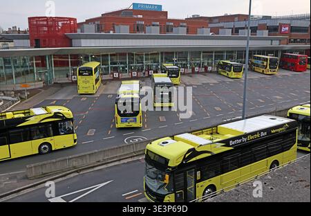Warrington central Bus Interchange in Cheshire, filled with yellow Warrington’s Own Buses electric buses at the town centre transport hub. Stock Photo
