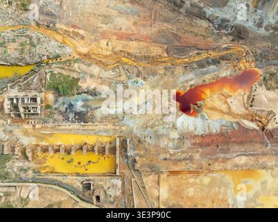 Old mining site and deep orange-red hues in the water of a pool in the mineral-rich area of the Rio Tinto mines. The colour is caused by oxidised iron Stock Photo