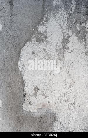 A high-resolution shot of an old concrete wall featuring a rich, distressed texture of mixed grey and white tones. The surface displays authentic weat Stock Photo