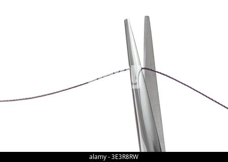 sewing scissors cutting thread on white isolated background Stock Photo