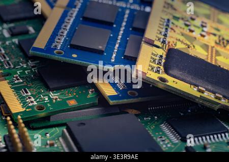 Memory chips are placed on a workbench showing circuit details during a tech project in a workshop with natural light. Stock Photo